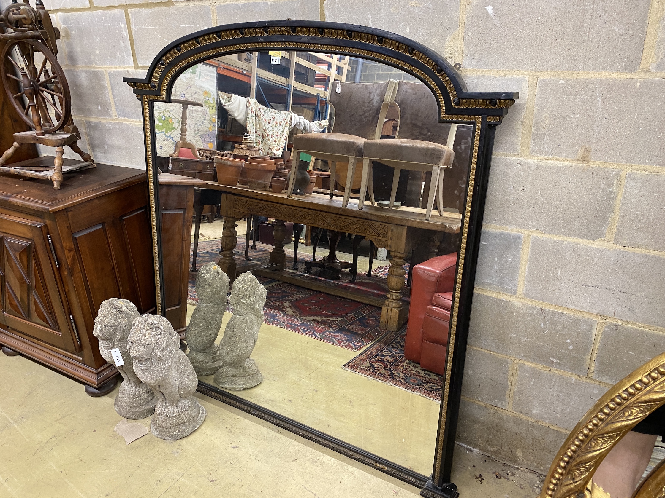 A late Victorian ebonised parcel gilt overmantel mirror, width 151cm, height 154cm